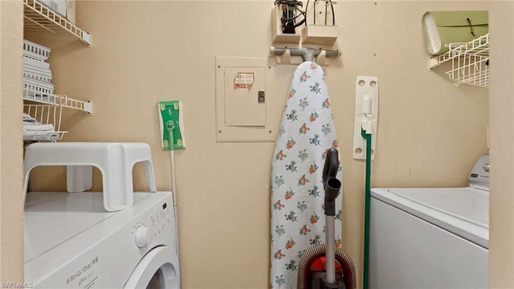 45 High Point Circle South, Unit 304 Naples, FL 34103 - Photo 18 of 20 a utility room with dryer and washer