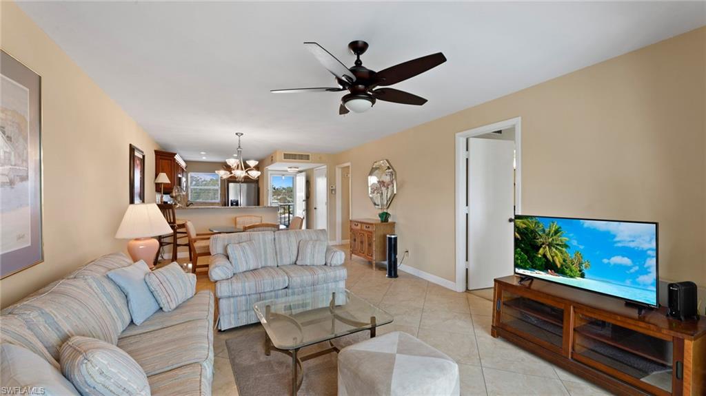 45 High Point Circle South, Unit 304 Naples, FL 34103 - Photo 4 of 20 a living room with furniture and a flat screen tv