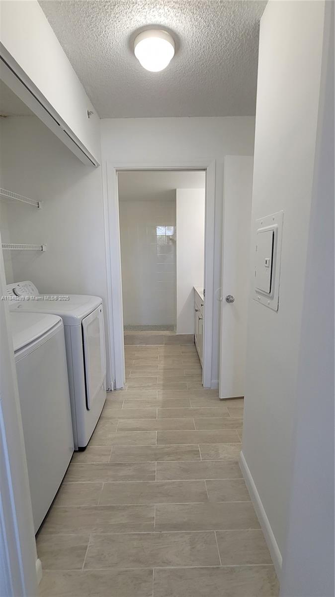 2021 Renaissance Boulevard, Unit 104 Miramar, FL 33025 - Photo 12 of 16 a view of a bathroom with sink and washing machine