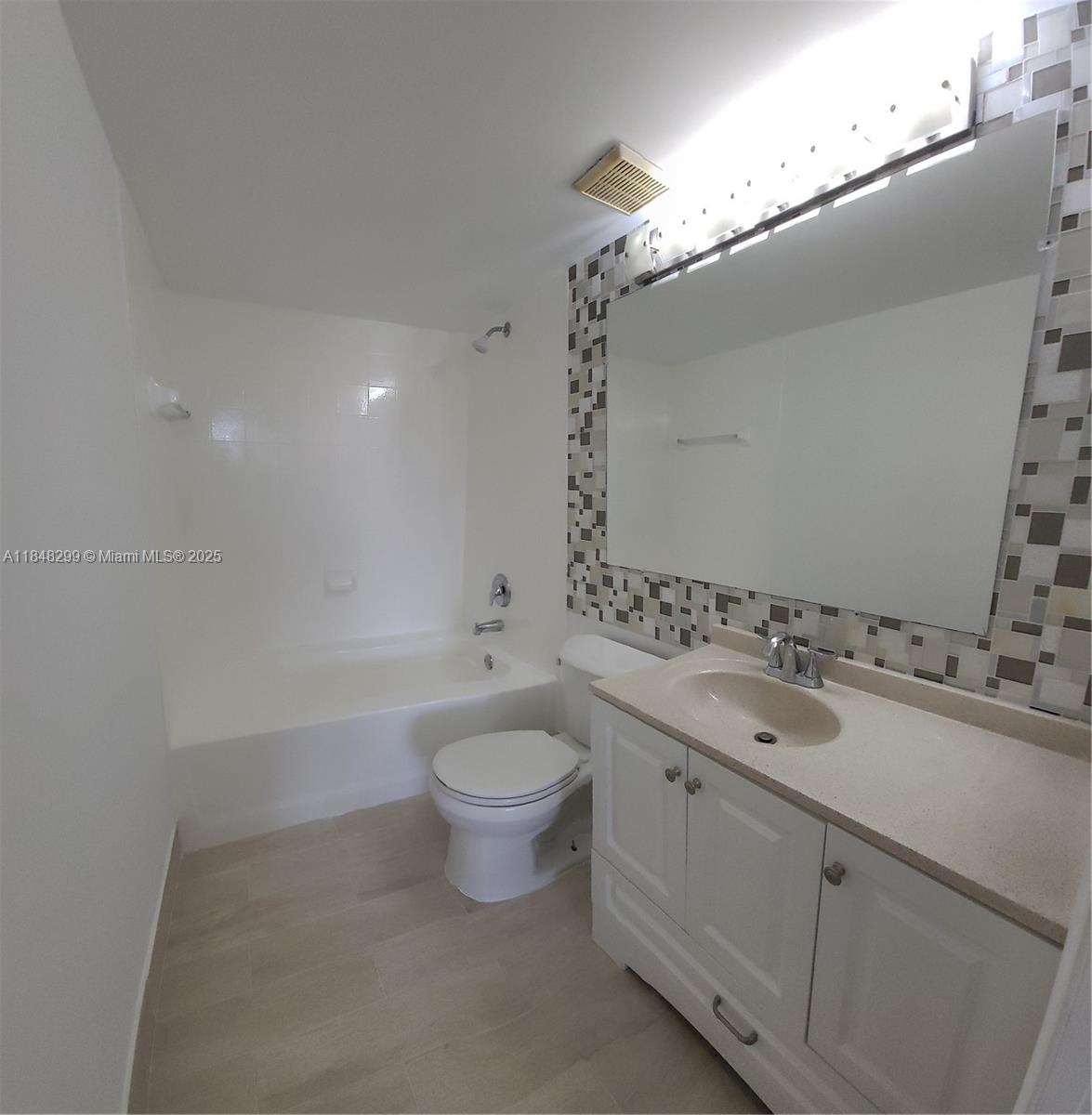 2021 Renaissance Boulevard, Unit 104 Miramar, FL 33025 - Photo 13 of 16 a bathroom with a toilet a sink and bathtub