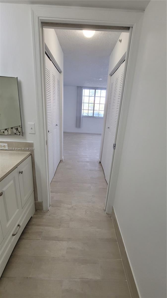 2021 Renaissance Boulevard, Unit 104 Miramar, FL 33025 - Photo 15 of 16 a view of a hallway with washer and dryer