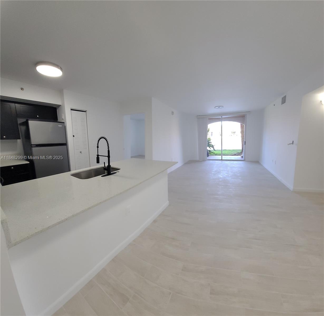 2021 Renaissance Boulevard, Unit 104 Miramar, FL 33025 - Photo 2 of 16 a bedroom with a bed and a mirror