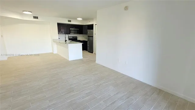 a view of a kitchen with a sink