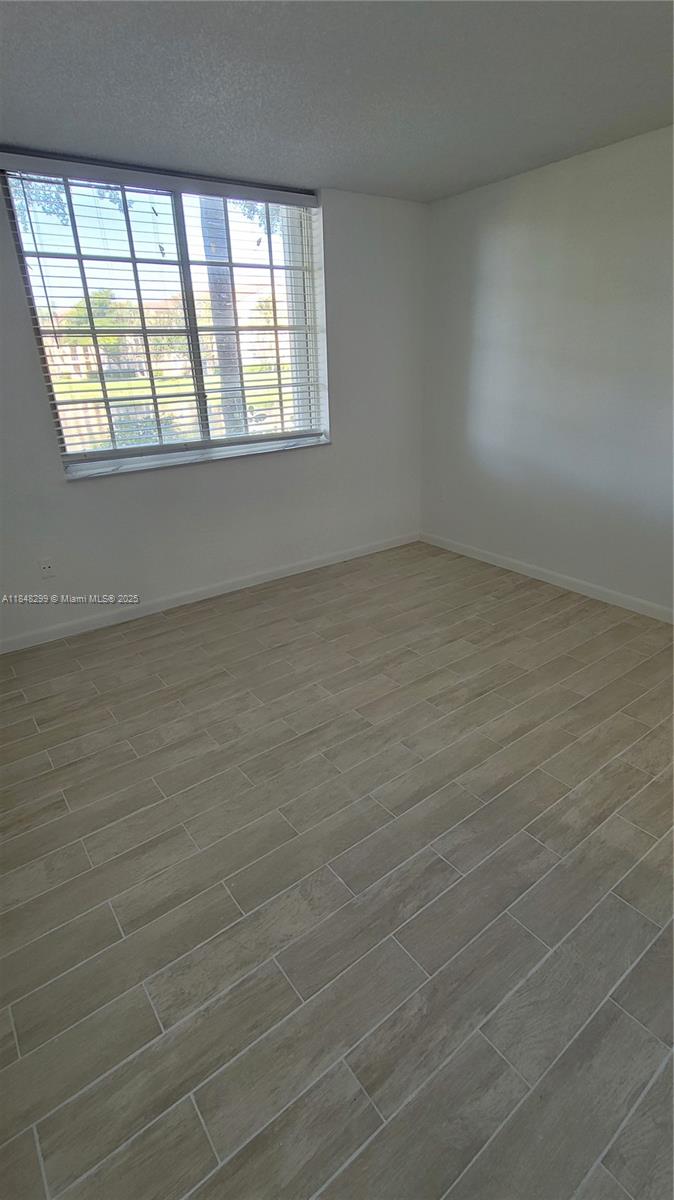 2021 Renaissance Boulevard, Unit 104 Miramar, FL 33025 - Photo 9 of 16 an empty room with a window