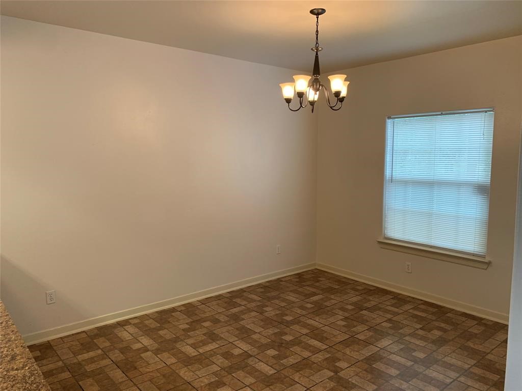 1513 Cage Street, Unit A Houston, TX 77020 - Photo 13 of 17 a view of a chandelier in an empty room
