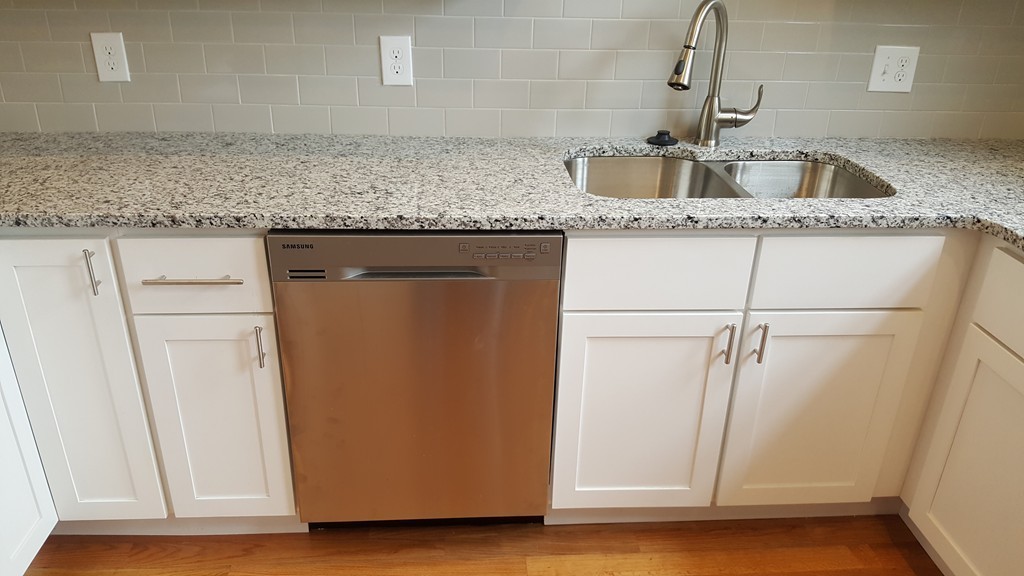 25 Robey Street, Unit 25 Boston, MA 02119 - Photo 3 of 13 a kitchen with stainless steel appliances granite countertop a sink and a granite counter tops