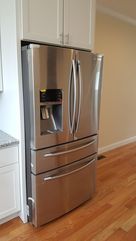 25 Robey Street, Unit 25 Boston, MA 02119 - Photo 5 of 13 a close view of a refrigerator and stove in a kitchen