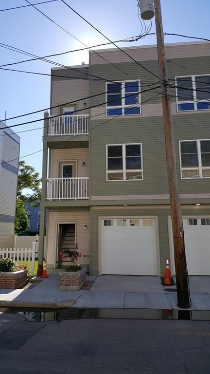 25 Robey Street, Unit 25 Boston, MA 02119 - Photo 9 of 13 a view of house with entryway and a garage