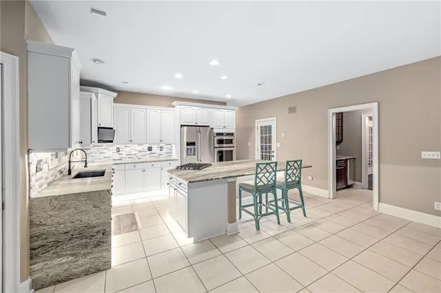 an empty room with windows and chandelier fan