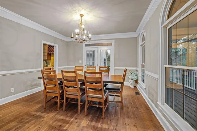 a spacious bedroom with a bed and a chandelier