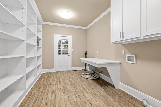 a kitchen with stainless steel appliances granite countertop a refrigerator a sink a stove with wooden cabinets and wooden floor