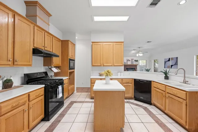 a kitchen with stainless steel appliances a sink stove and cabinets