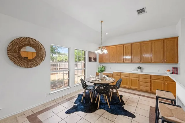 a view of a dining room with furniture and chandelier