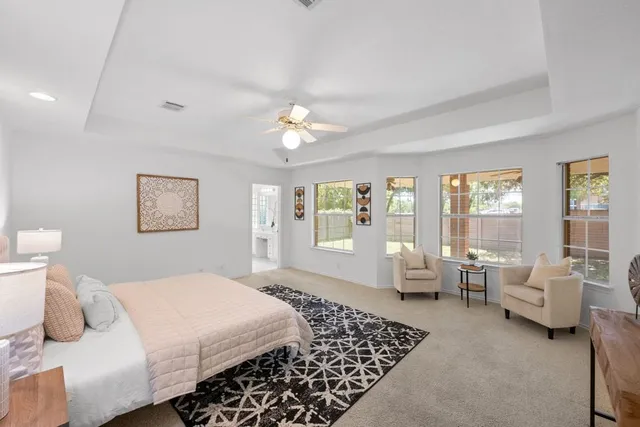 a bedroom with a large bed and a couch