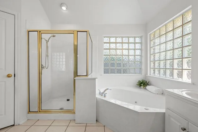 a bathroom with a bathtub and a shower