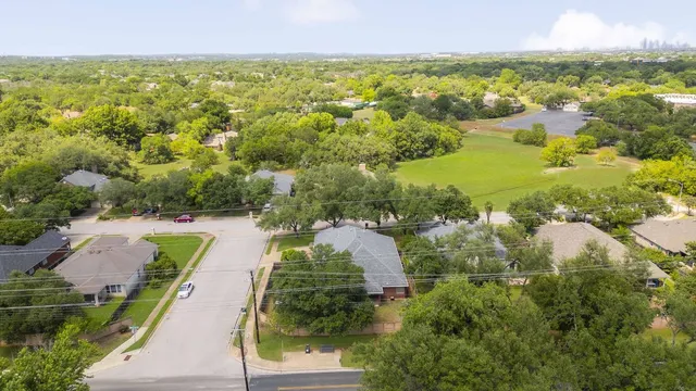 an aerial view of a house with a yard