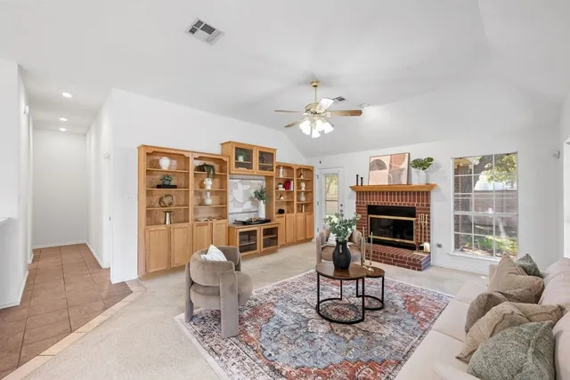 a living room with furniture a fireplace and a table