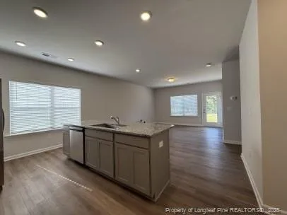 a kitchen with stainless steel appliances granite countertop a sink and stove top oven