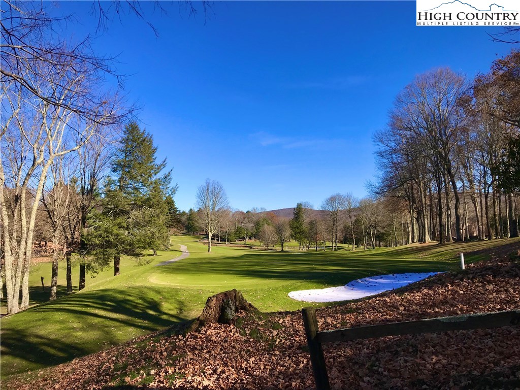 104 Pine Ridge Road Beech Mountain, NC 28604 - Photo 2 of 25 a view of a golf course with a lake