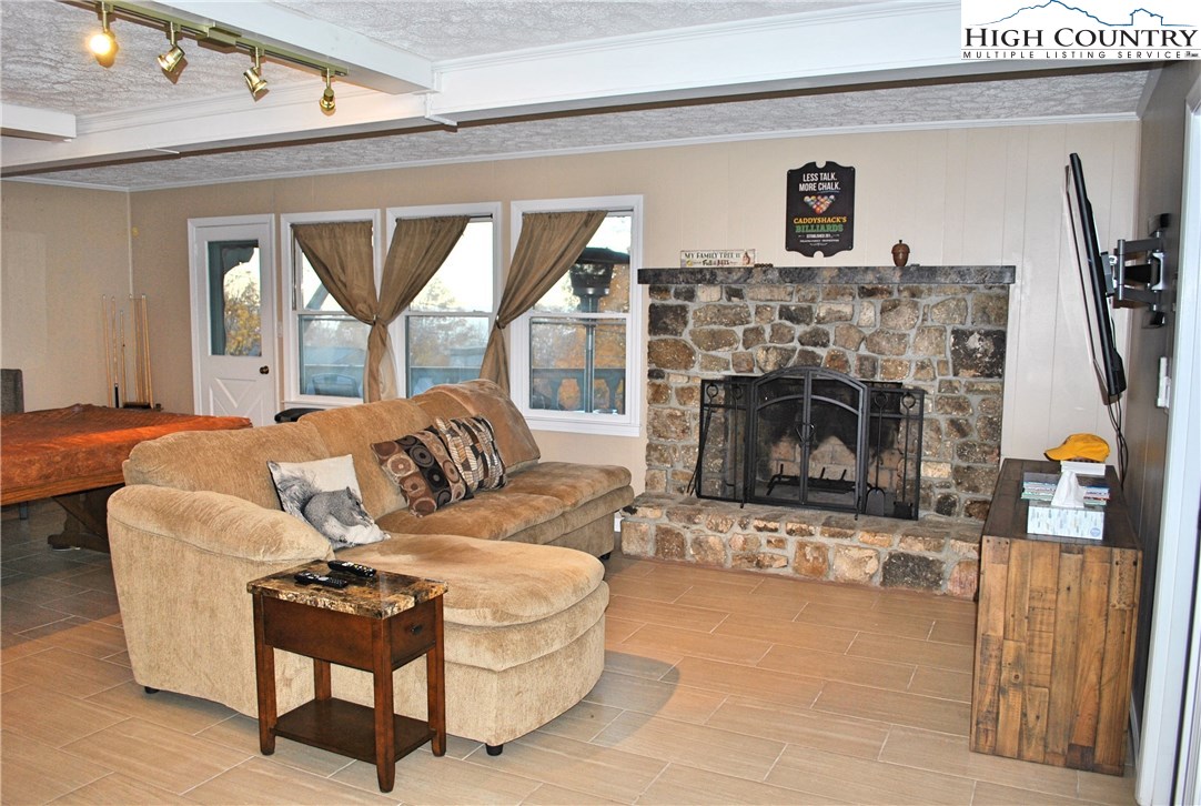104 Pine Ridge Road Beech Mountain, NC 28604 - Photo 21 of 25 a living room with furniture and a fireplace