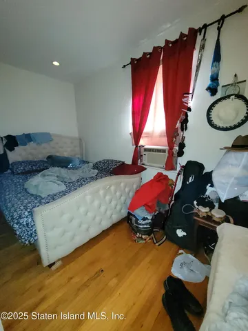 a bedroom with a bed and dresser