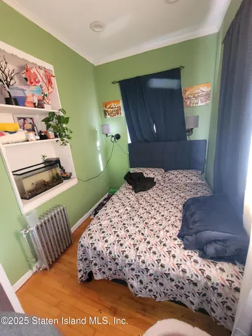 a living room with stainless steel appliances furniture a kitchen view and a flat screen tv