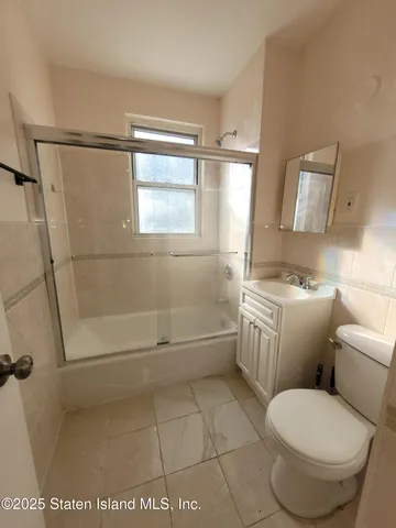 a view of a hallway with wooden shelves