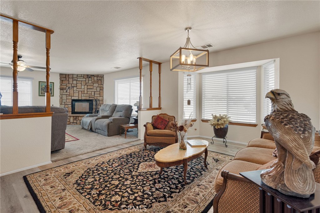 21291 Ramona Road Apple Valley, CA 92307 - Photo 12 of 35 a living room with furniture or couch and a fireplace