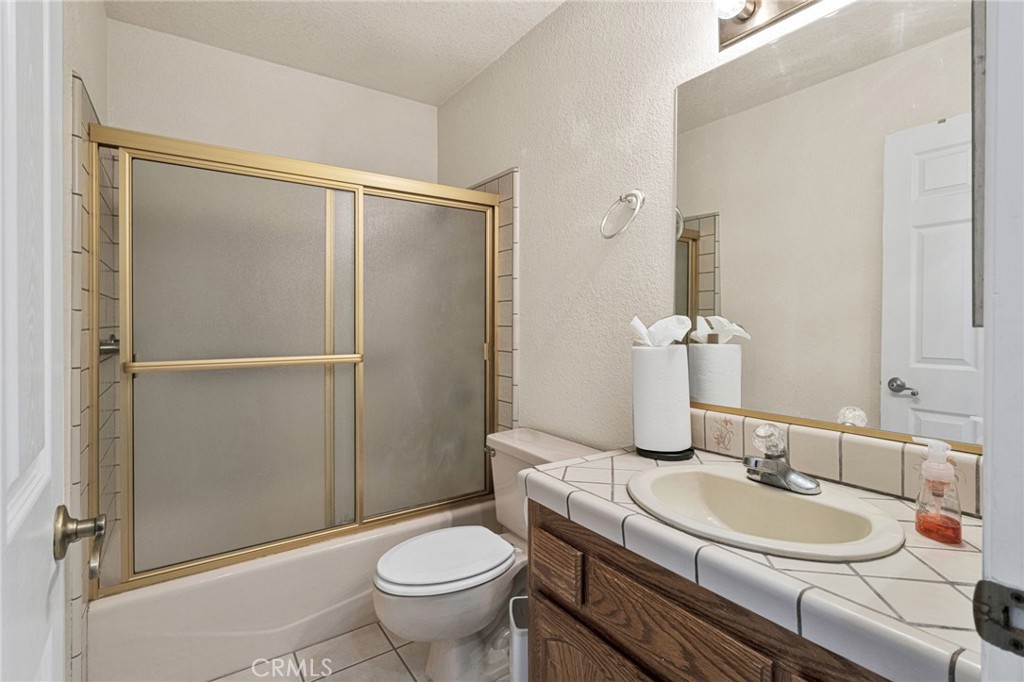 21291 Ramona Road Apple Valley, CA 92307 - Photo 17 of 35 a bathroom with a sink toilet and shower