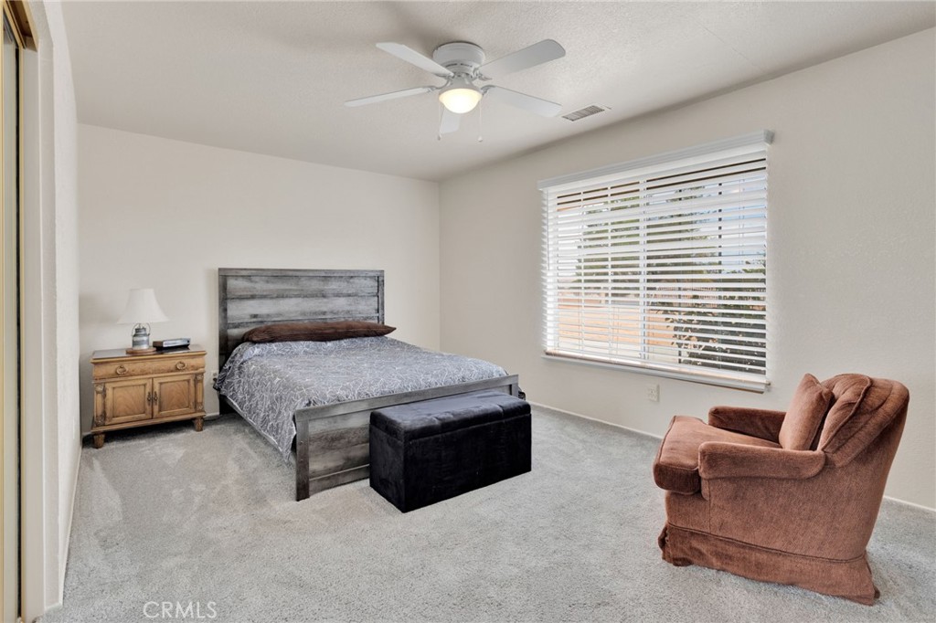 21291 Ramona Road Apple Valley, CA 92307 - Photo 18 of 35 a bedroom with furniture and window