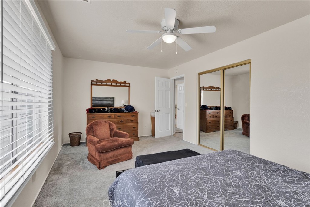 21291 Ramona Road Apple Valley, CA 92307 - Photo 19 of 35 a bedroom with a bed and a television