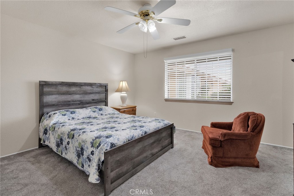 21291 Ramona Road Apple Valley, CA 92307 - Photo 20 of 35 a bedroom with bed and a couch