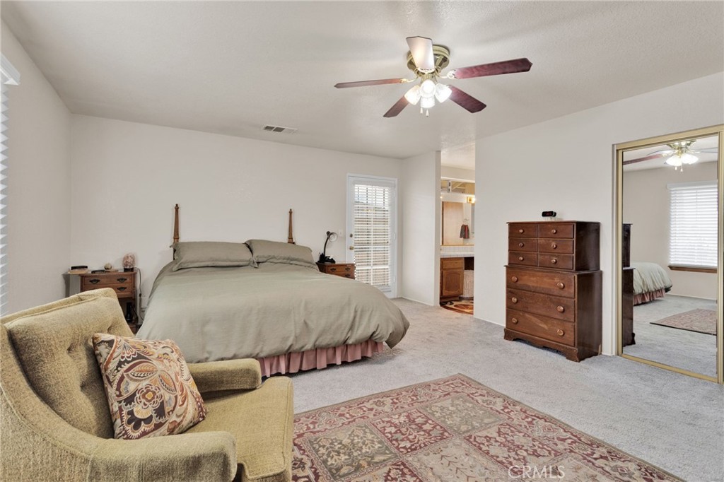 21291 Ramona Road Apple Valley, CA 92307 - Photo 24 of 35 a spacious bedroom with a bed and ceiling fan