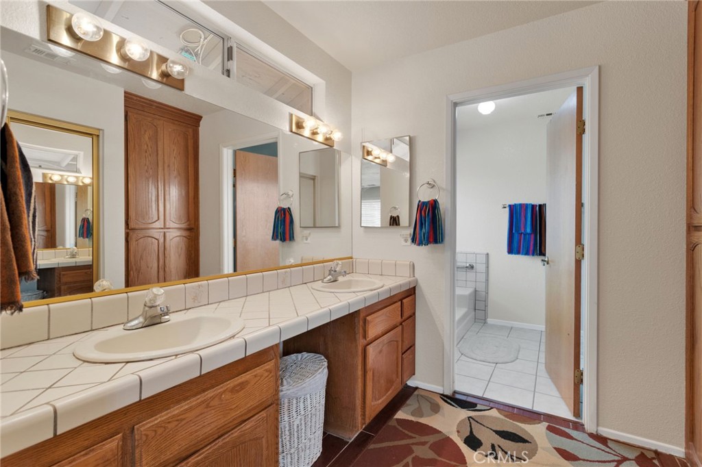 21291 Ramona Road Apple Valley, CA 92307 - Photo 26 of 35 a spacious bathroom with a sink double vanity and a mirror