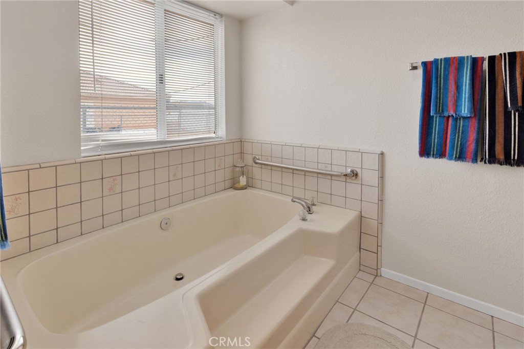 21291 Ramona Road Apple Valley, CA 92307 - Photo 27 of 35 a bathroom with a bathtub and a shower