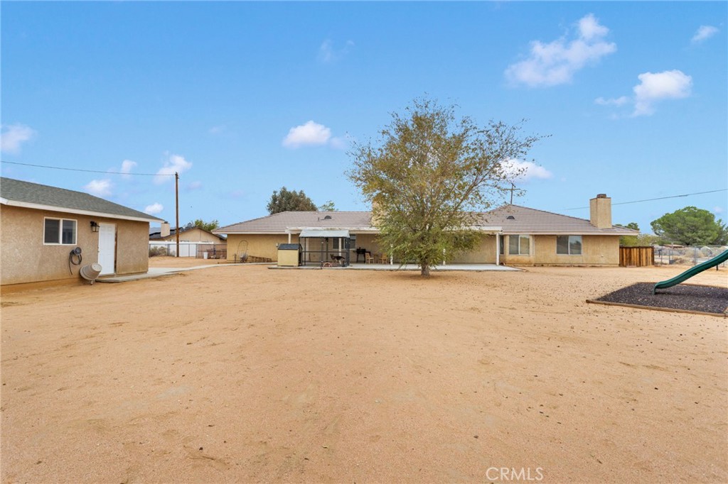 21291 Ramona Road Apple Valley, CA 92307 - Photo 33 of 35 a front view of a house with a road and yard