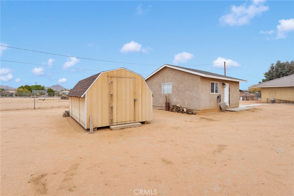 21291 Ramona Road Apple Valley, CA 92307 - Photo 34 of 35 a view of a house with a yard