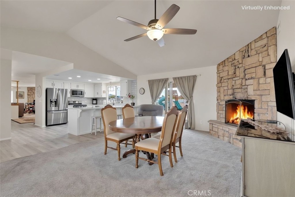 21291 Ramona Road Apple Valley, CA 92307 - Photo 8 of 35 a dining room with furniture and a fireplace