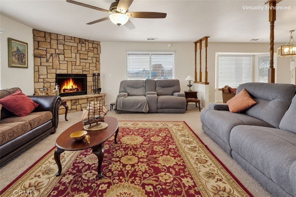 21291 Ramona Road Apple Valley, CA 92307 - Photo 9 of 35 a living room with furniture and a fireplace