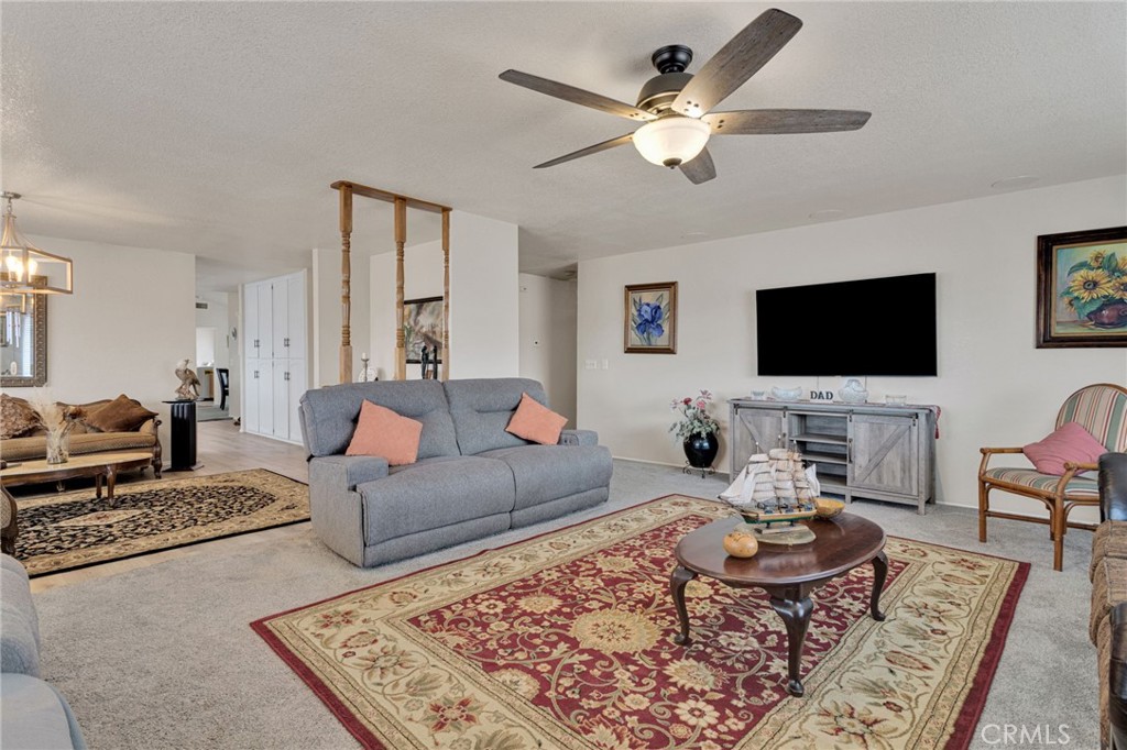 21291 Ramona Road Apple Valley, CA 92307 - Photo 10 of 35 a living room with furniture a rug and a flat screen tv