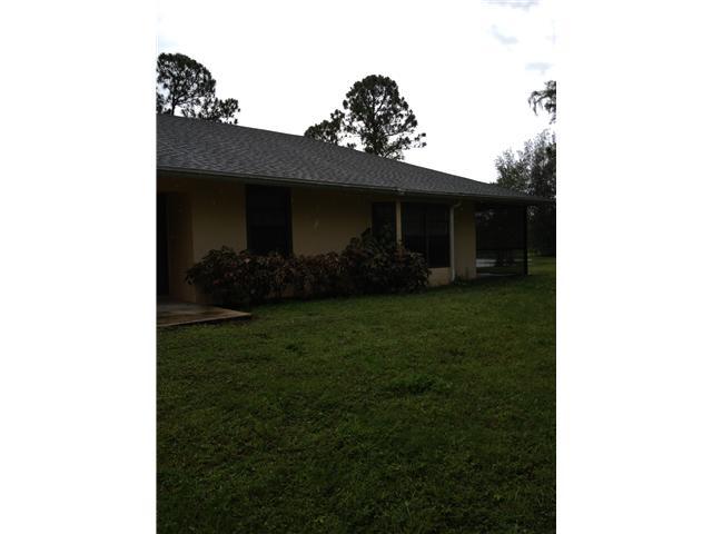 13188 Sand Ridge Road Palm Beach Gardens, FL 33418 - Photo 1 of 7 a view of a house with a yard