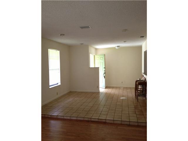 13188 Sand Ridge Road Palm Beach Gardens, FL 33418 - Photo 4 of 7 a view of an empty room with wooden floor