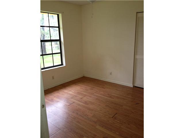 13188 Sand Ridge Road Palm Beach Gardens, FL 33418 - Photo 7 of 7 a view of an empty room with wooden floor and a window