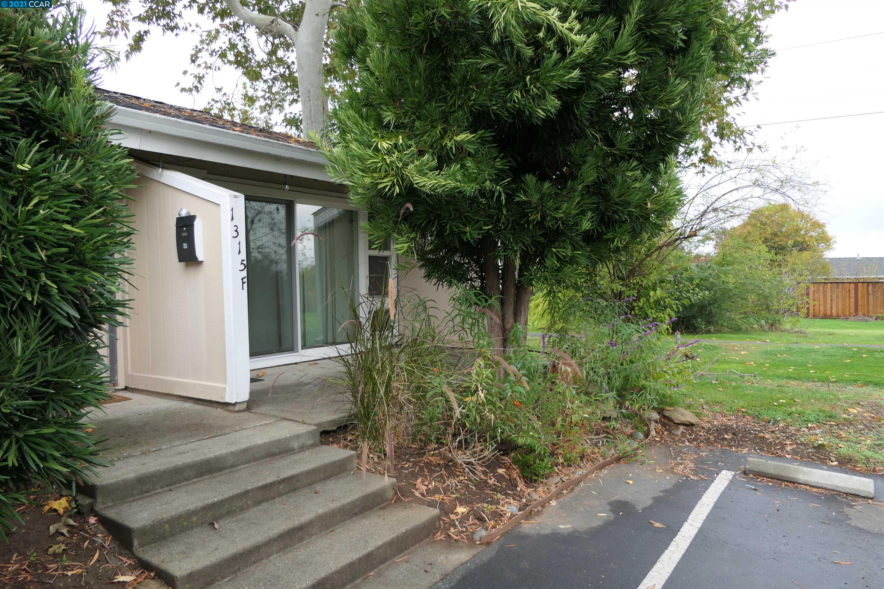 1315 Kenwal Road, Unit F Concord, CA 94521 - Photo 1 of 1 a front view of a house with garden
