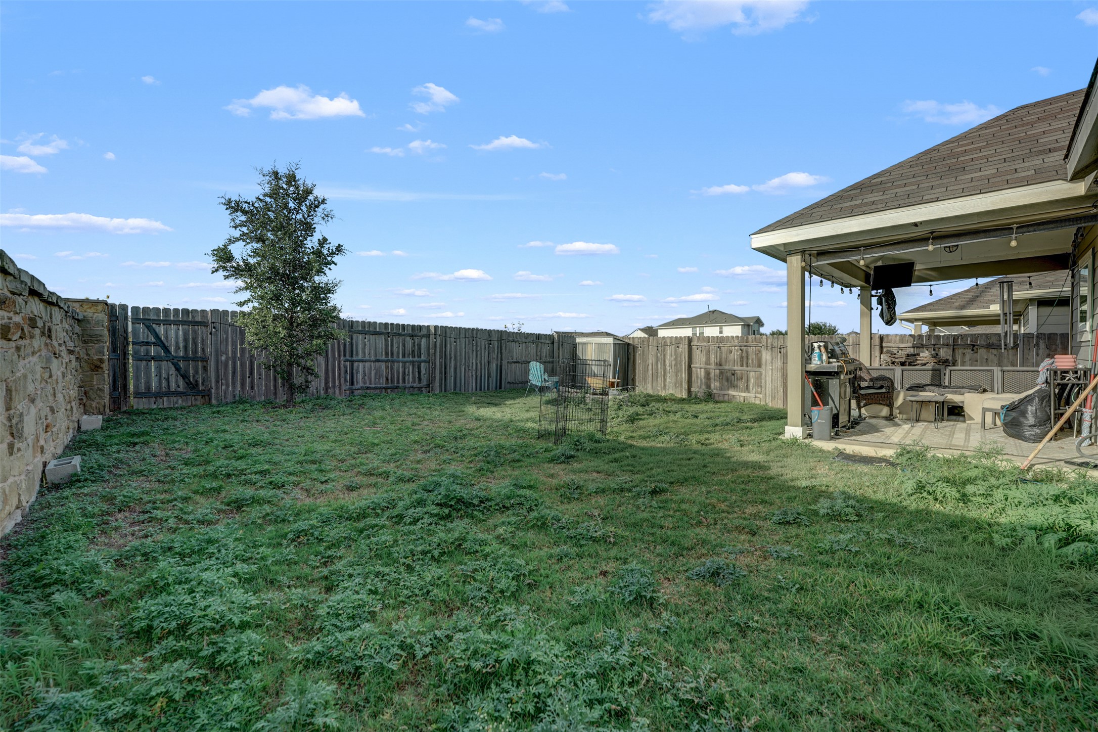 5806 Aviano Road Round Rock, TX 78665 - Photo 8 of 29 A spacious backyard provides ample green space and a covered patio perfect for outdoor enjoyment.