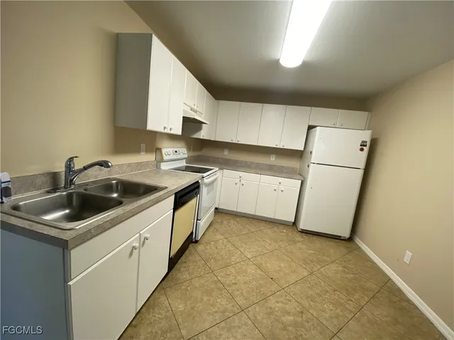 a kitchen that has a sink and a stove in it
