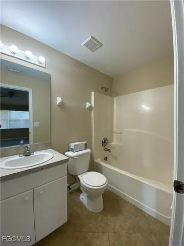a bathroom with a double vanity sink toilet mirror and shower