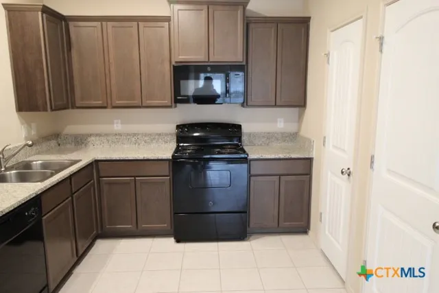 a kitchen with a sink and a stove