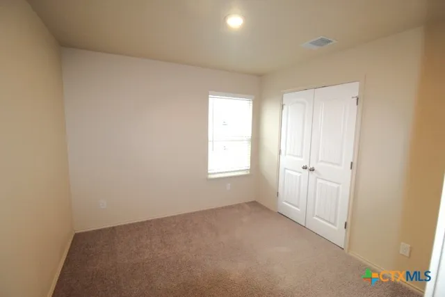 a view of an empty room and a window