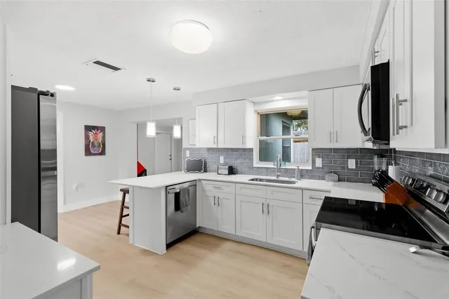 a kitchen with a sink stove and cabinets